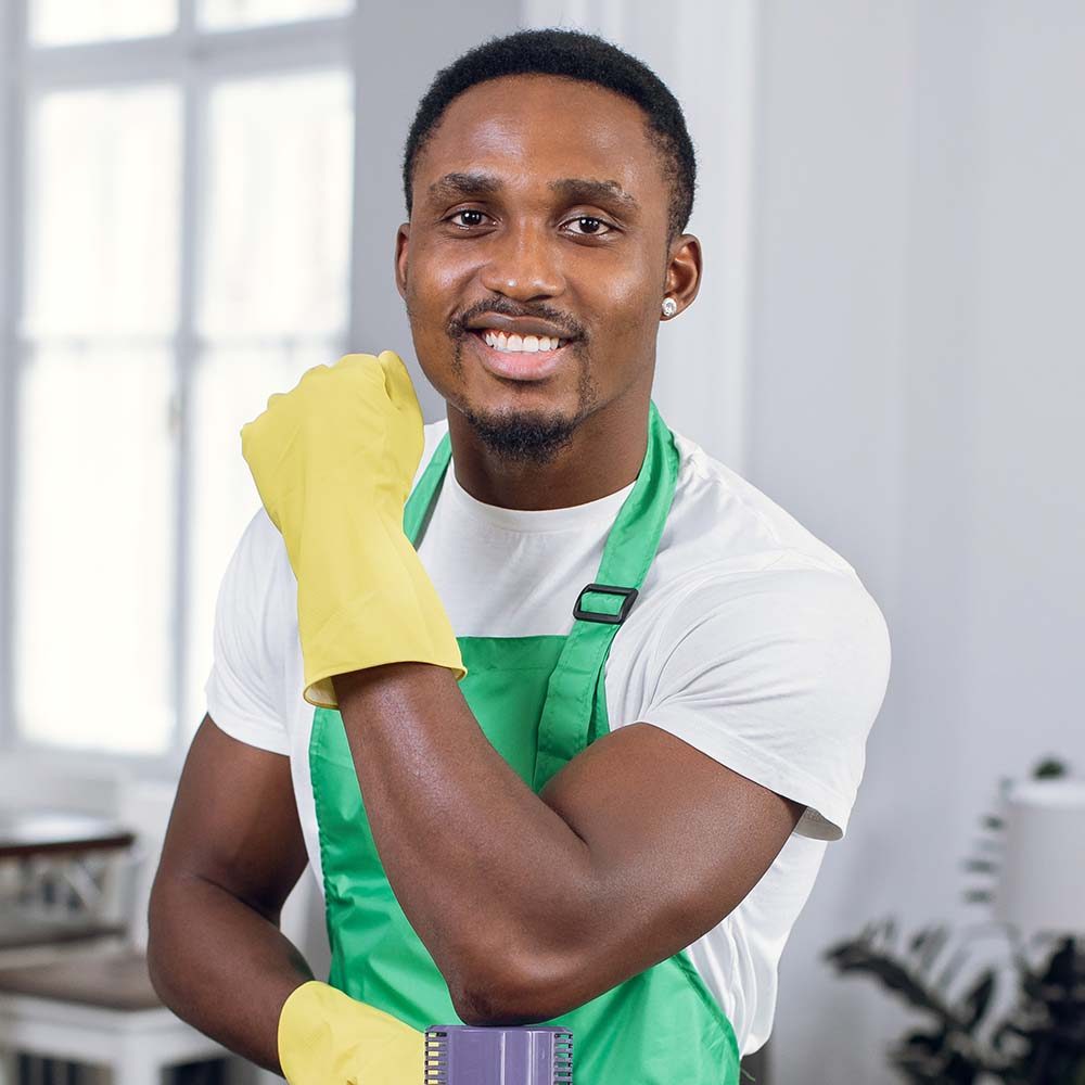 smiling-afro-american-man-posing-with-vacuum-clean3-9WGU8PA.jpg